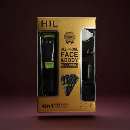HTC 4-in-1 men's face and body grooming kit in its gold and black retail box, displayed on a dark slatted surface with green leaves at the sides.